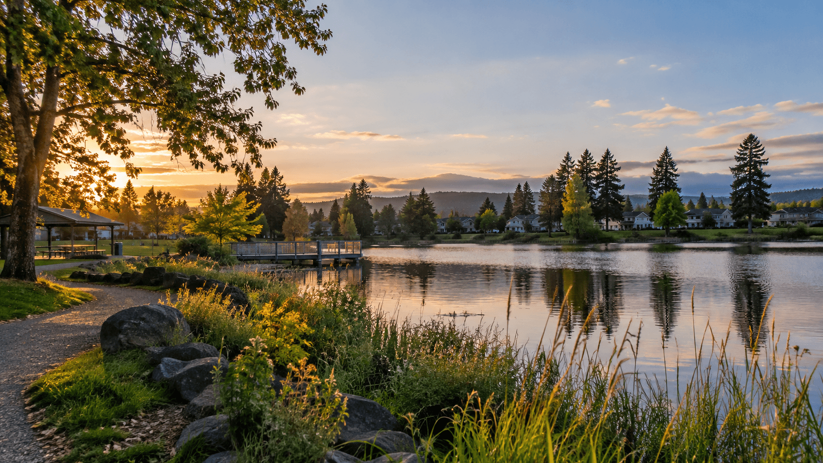 Fairview Lake at sunset with homes and park reflected in the water.