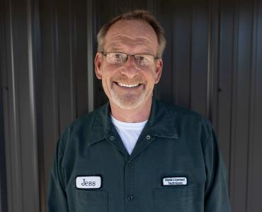 Man with glasses smiling for a photo