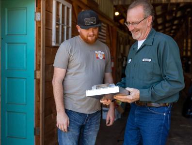 Two men looking at a clipboard